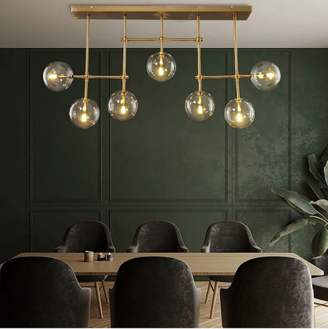 Видовжена люстра з прозорими плафонами в корпусі латунь